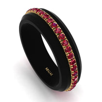 A men's wedding band with round ruby stones set in a black titanium band with a gold accent.